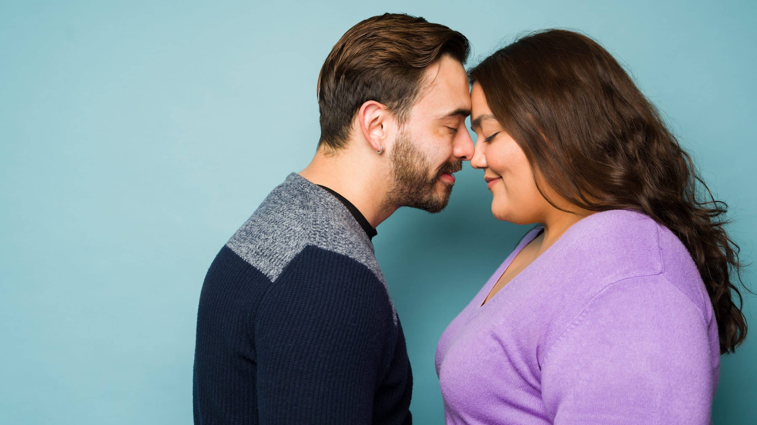Fat woman and man pressing heads against each other romantically