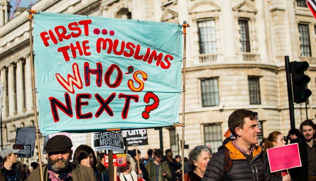 Protestor carries sign stating “First…The Muslims. Who’s Next?”