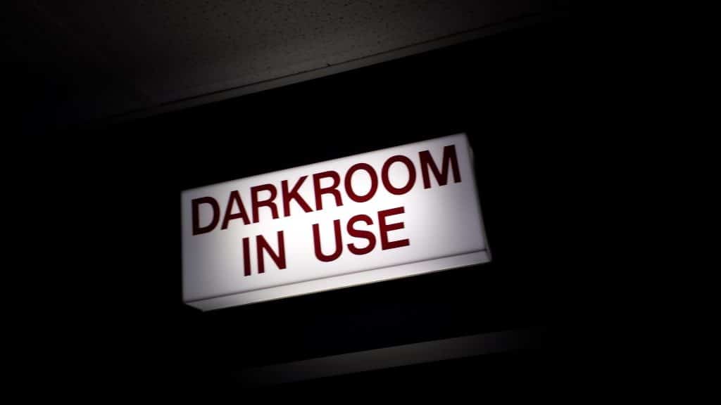 Photograph of sign that says "darkroom in use"
