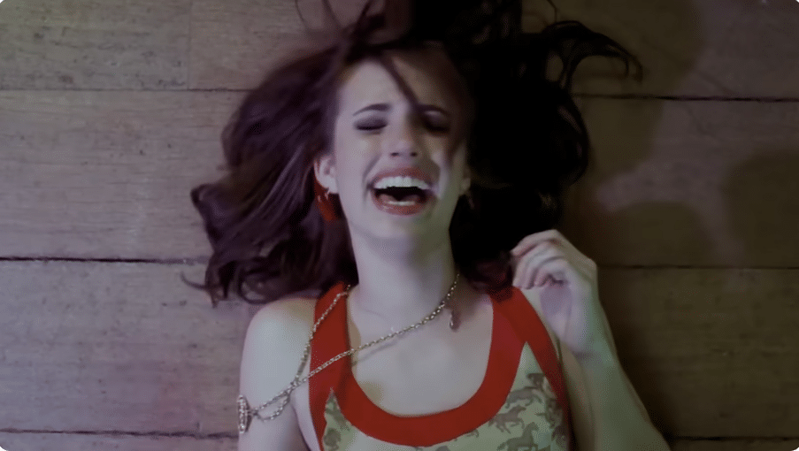Poppy Moore smiling on the floor