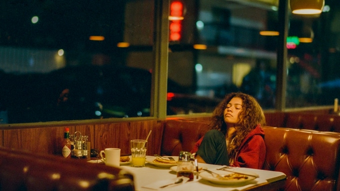 Zendaya sat in a diner booth by herself with her eyes closed contemplating during the season one special episode.