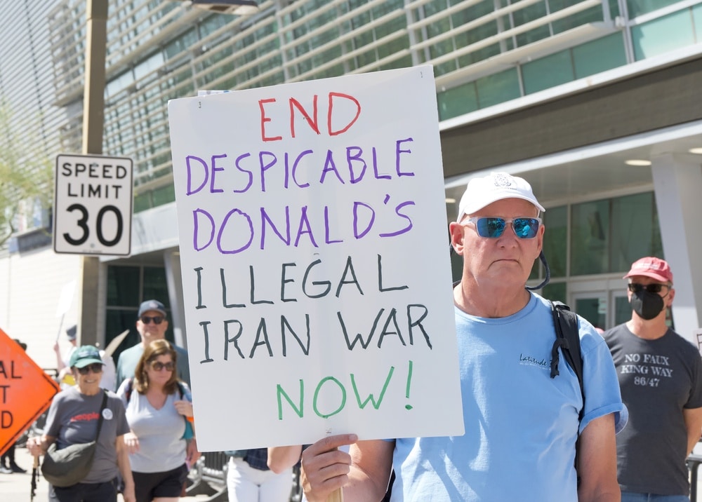 unidentified people holding signs for the NO KINGS DAY rally in Downtown Phoenix
