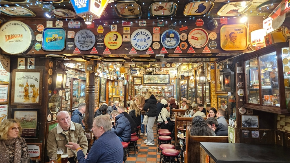 A decorative Irish pub with plenty of people gathered in community
