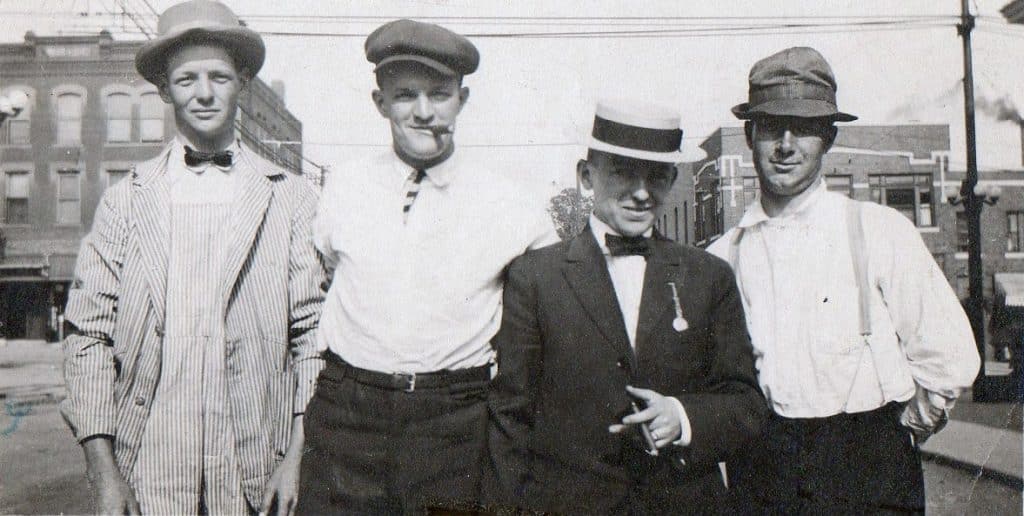 A family of four male Irish immigrants in hats posing together in Kansas City, Missouri.