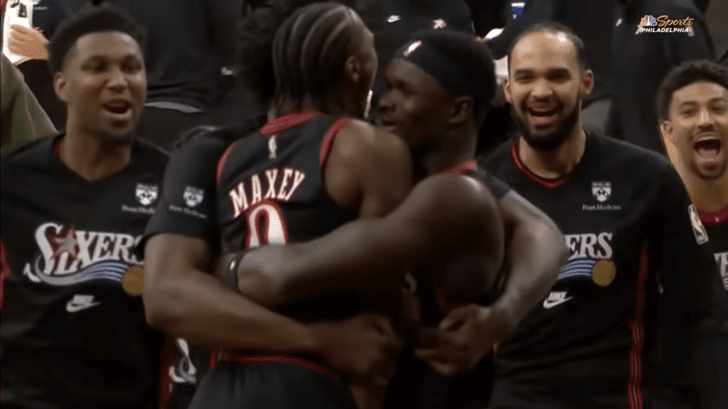 Tyrese Maxey celebrates with teammates following a clutch game-winner.