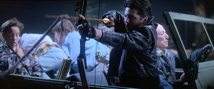 Kid shooting an arrow at a monster attack in The Monster Squad