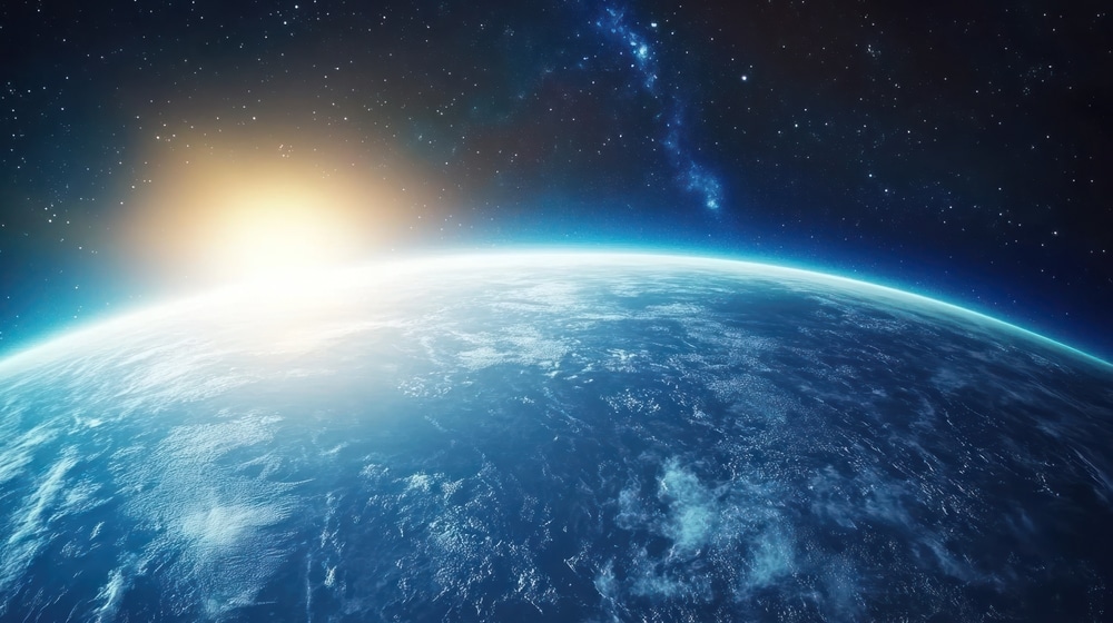 Earth from space with sun rising from behind