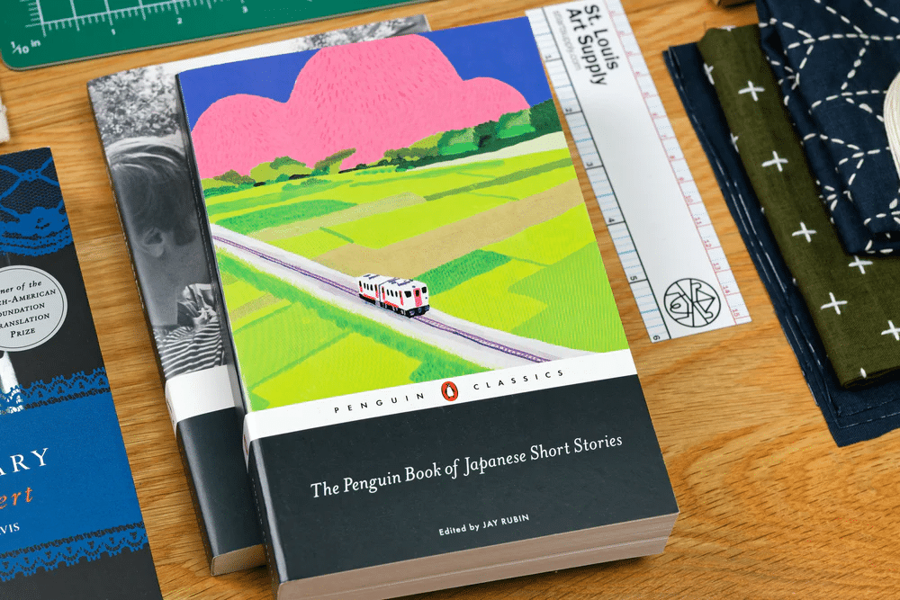 Countryside with a small road on the cover of Japanese Short Story anthology by Jay Rubin