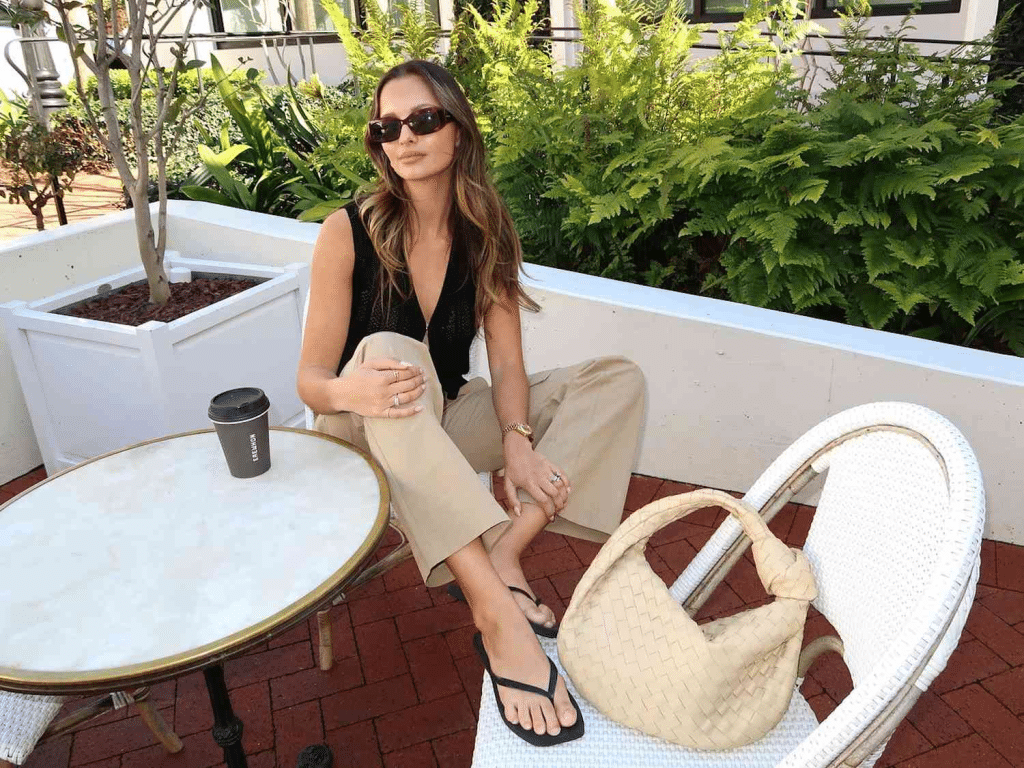 girl with black top and tan pants paired with black flip flops
