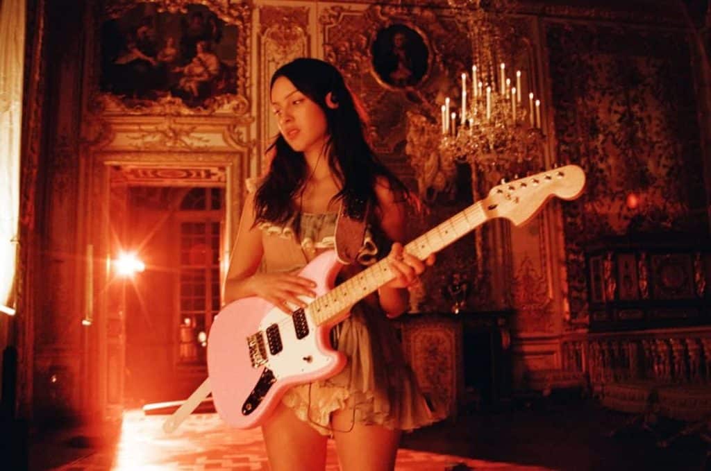 dim lit photo of guitarist in palace of versailles