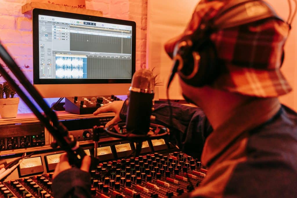 Producer working in a Digital Audio Workstation (DAW) to make music in their bedroom.