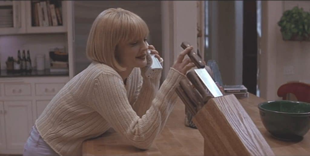 The image is a still from Scream 1996 featuring Drew Barrymore.