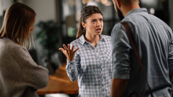 Three people having a heated discussion.