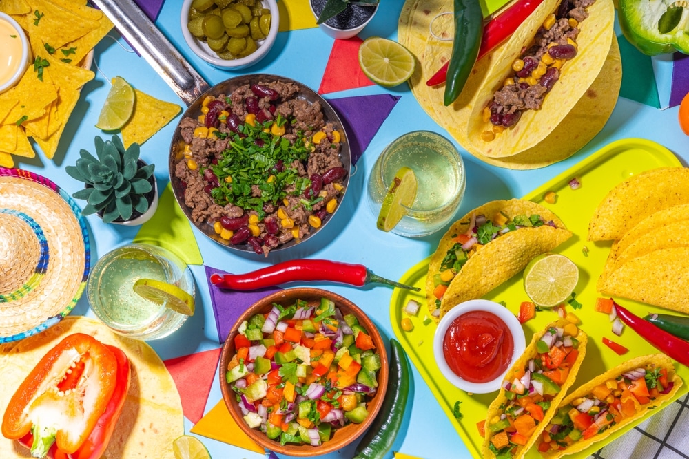 A table filled with Mexican food and drinks