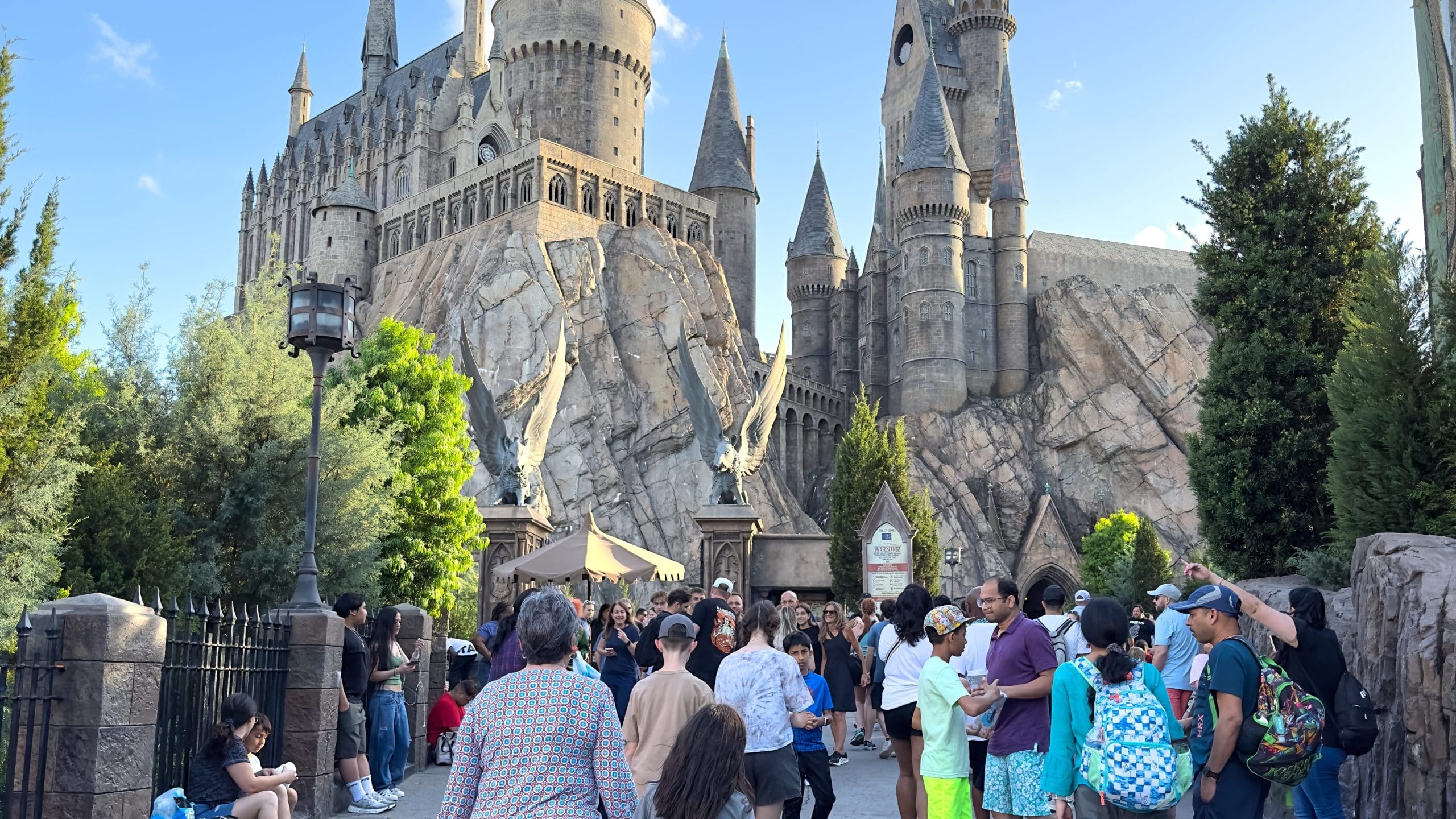 A crowd of people in front of Hogwarts Castle at Harry Potter World