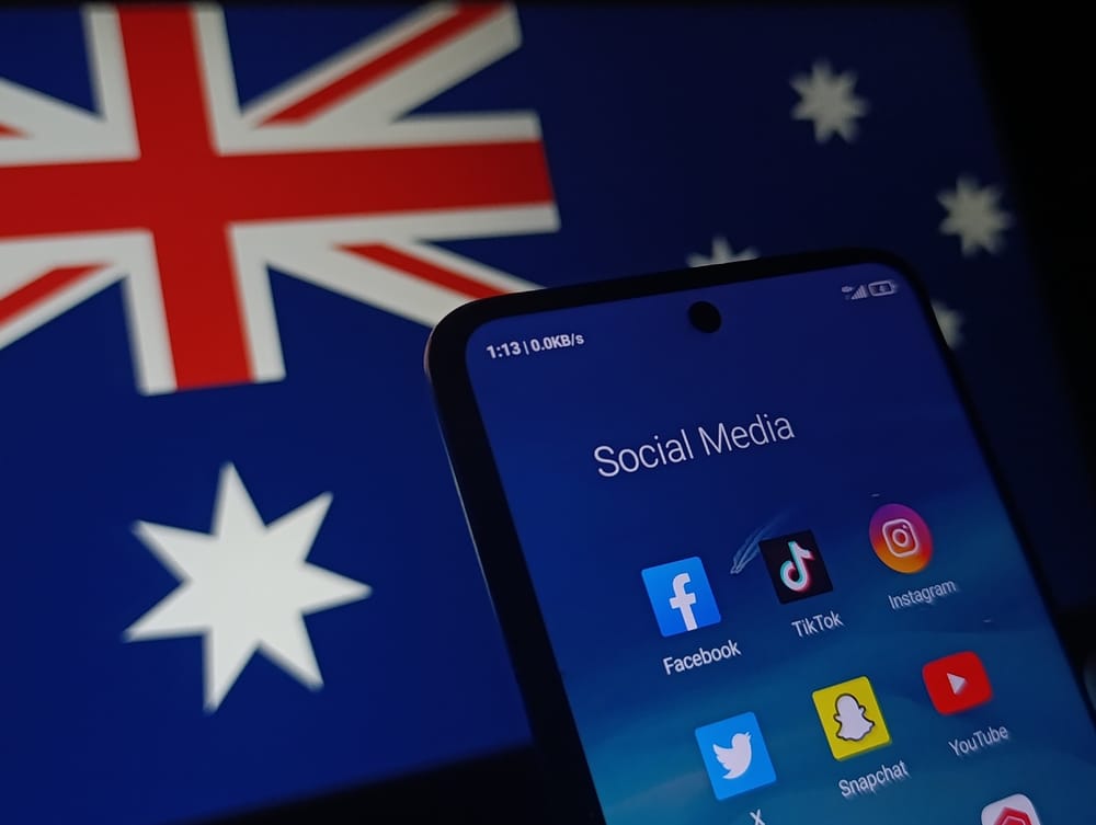 Australian flag and infant of it is a fine with a social media folder with key social media sites on there which Australia have banned for under 16's