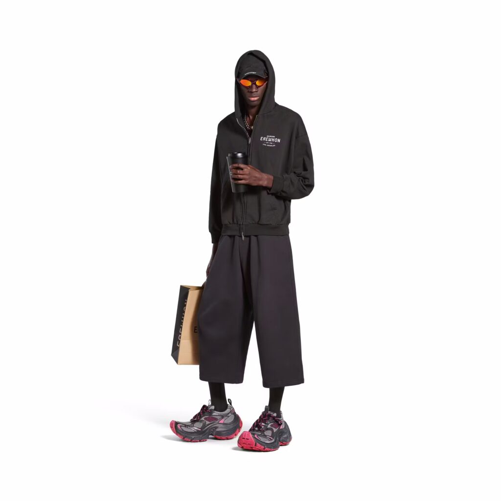 Image of a model posing while wearing the Balenciaga and Erewhon collaboration