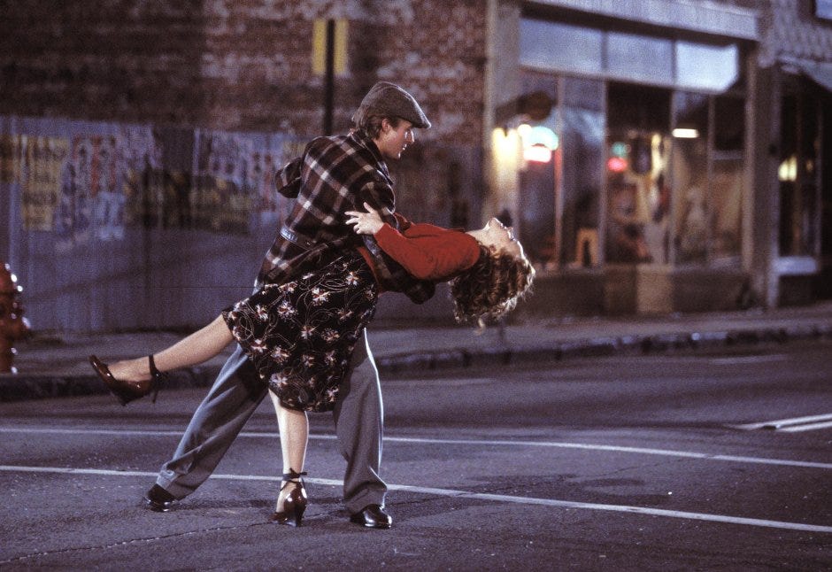 Noah Calhoun and Allie Hamilton from The Notebook movie dancing on the street.
