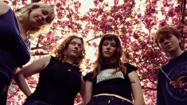 Members of Florence Road in front of a cherry blossom tree.