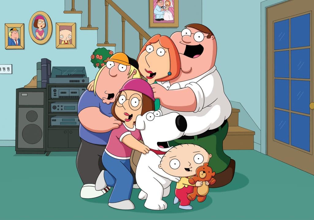 A scene from Family Guy that shows all the Griffin family close together in their home smiling for a family photo