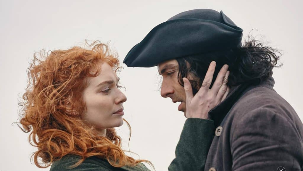 Demelza and Ross displaying their romance in emotional embrace outside in Poldark.