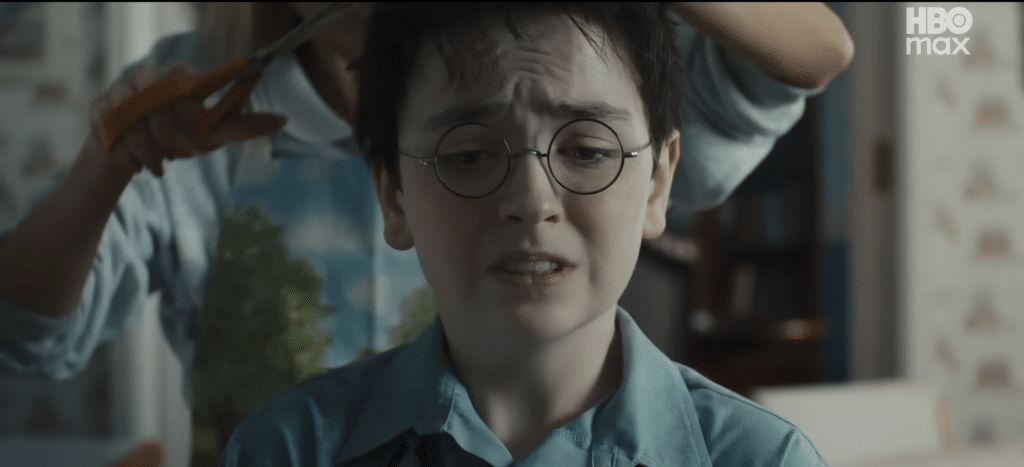 Harry flinches as Petunia cuts his hair aggressively.