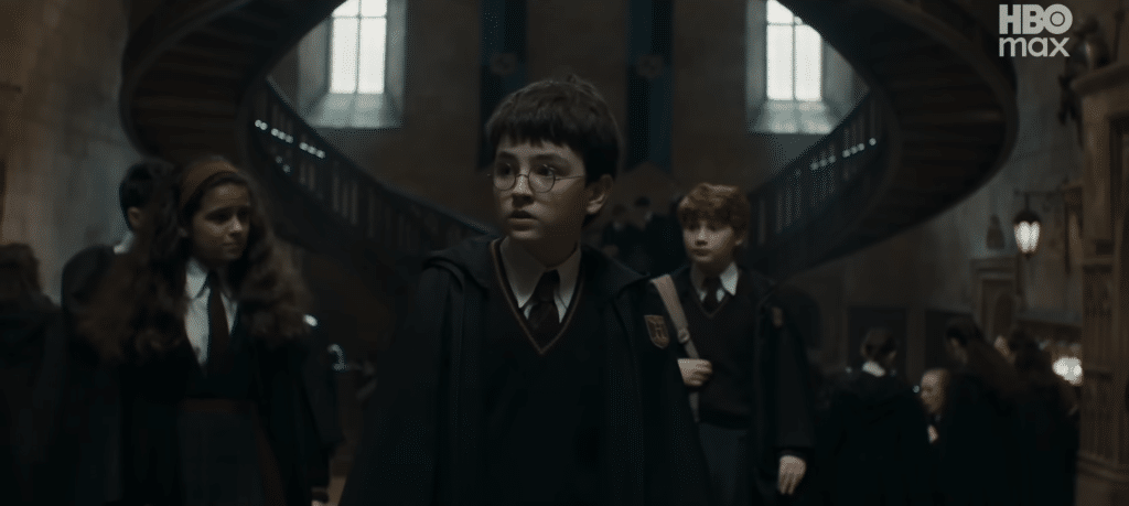Harry, Ron, and Hermione in walking through Hogwarts