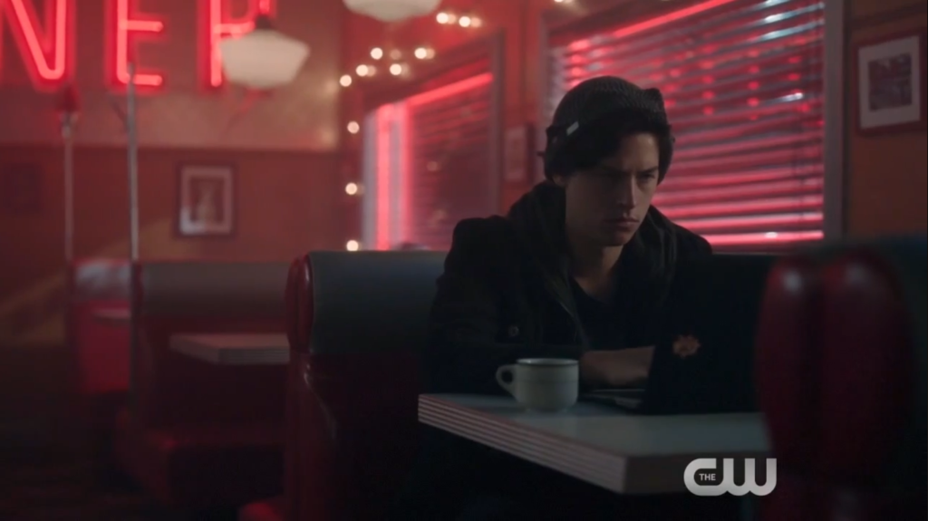 Jughead Jones writing in a diner(HBO Max/The CW)