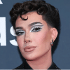 James Charles poses for the camera, wearing his iconic heavy makeup.