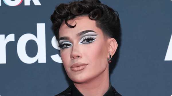 James Charles poses for the camera, wearing his iconic heavy makeup.