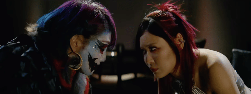 Asuka and Iyo Sky sit across from each other on WWE Raw