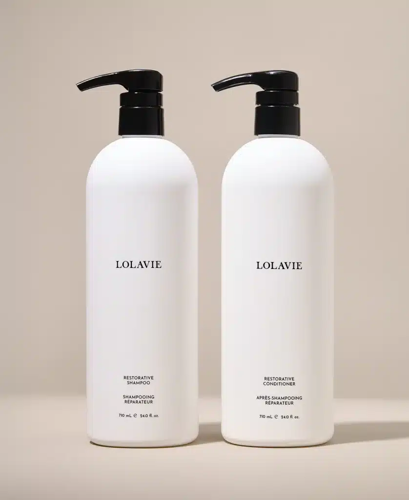 A stock photo of LolaVie Restorative Shampoo and Conditioner.