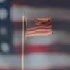 American Flag with a bigger flag in the background.