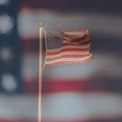 American Flag with a bigger flag in the background.