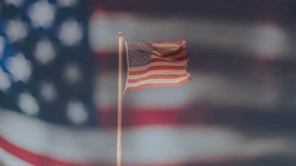 American Flag with a bigger flag in the background.