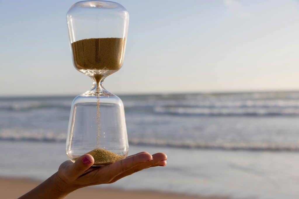 Hourglass running out of sand, signifying we only have so much time.