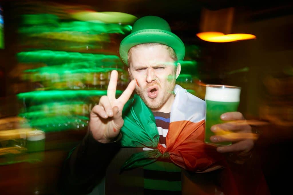 Drunk Irish man dressed in St. Patrick's Day attire.