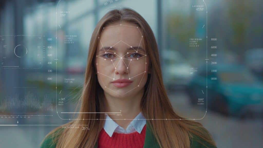 A portrait of a woman outdoors, overlaid with a facial recognition interface connecting lines across her face.