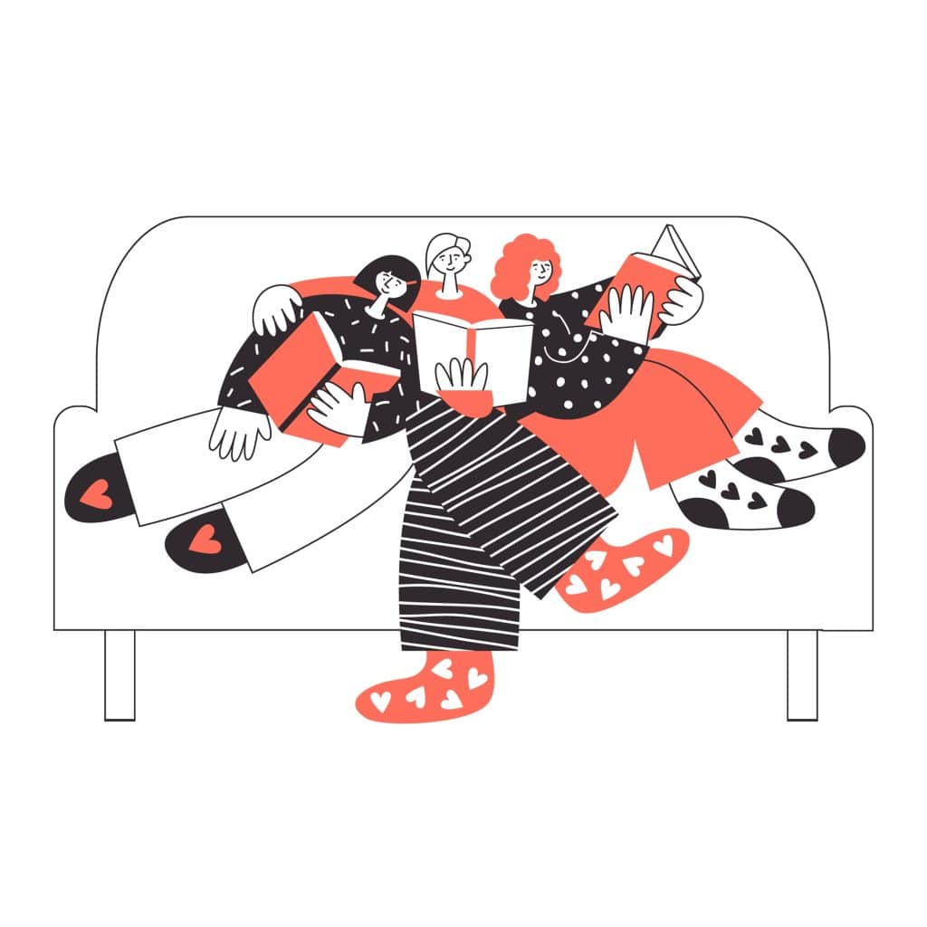 Three friends sitting on a couch reading books