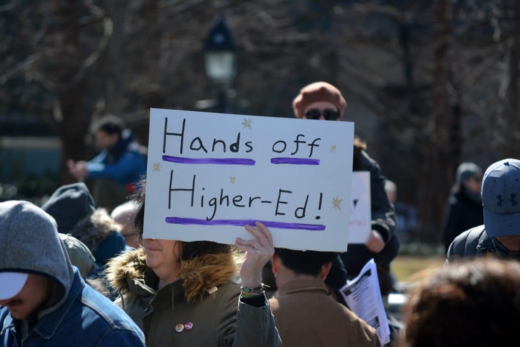 Protest sign that states "Hands off Higher - Education" in New York