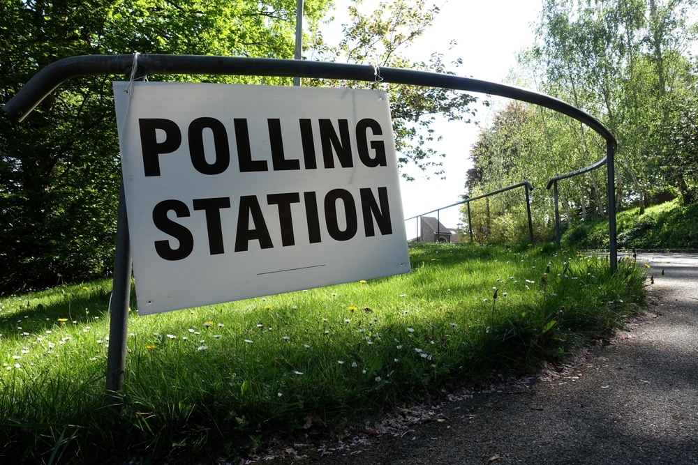 White sign that says 'Polling Station' to direct people on where to vote