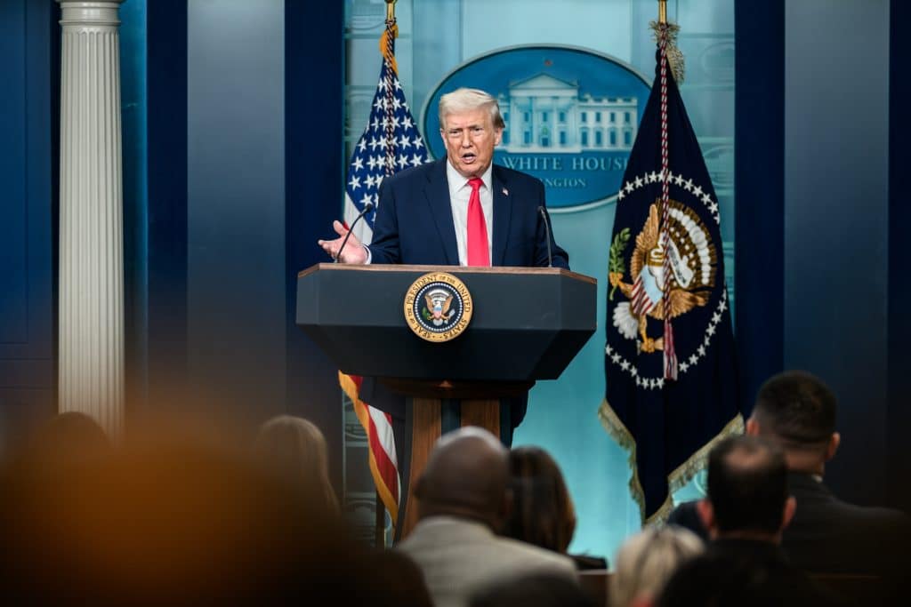 President Donald Trump giving a statement and has recently passed legislation regarding higher education.