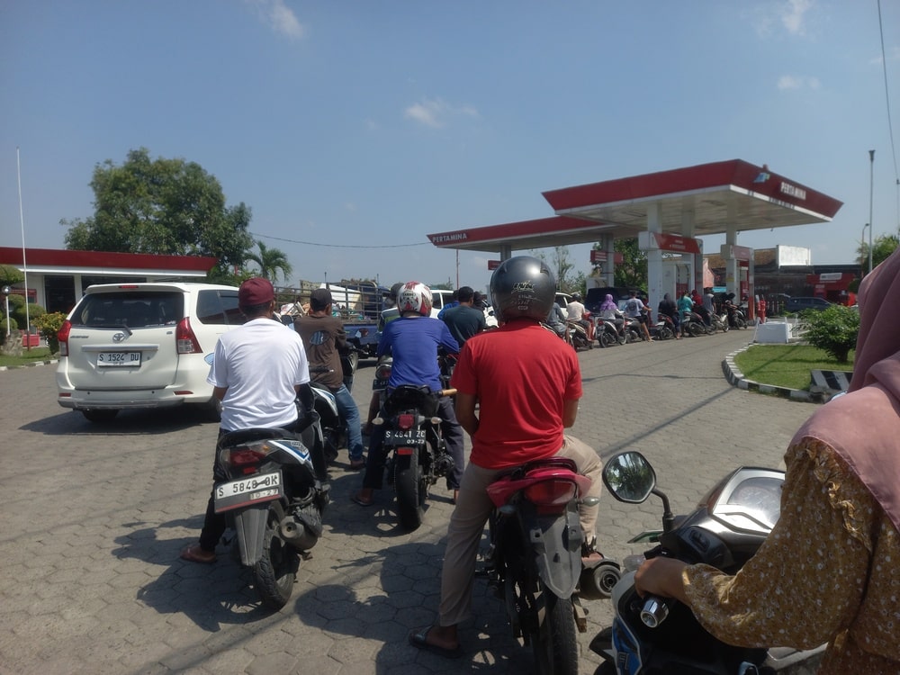 Motorcycles line up at the gas station to buy fuel.