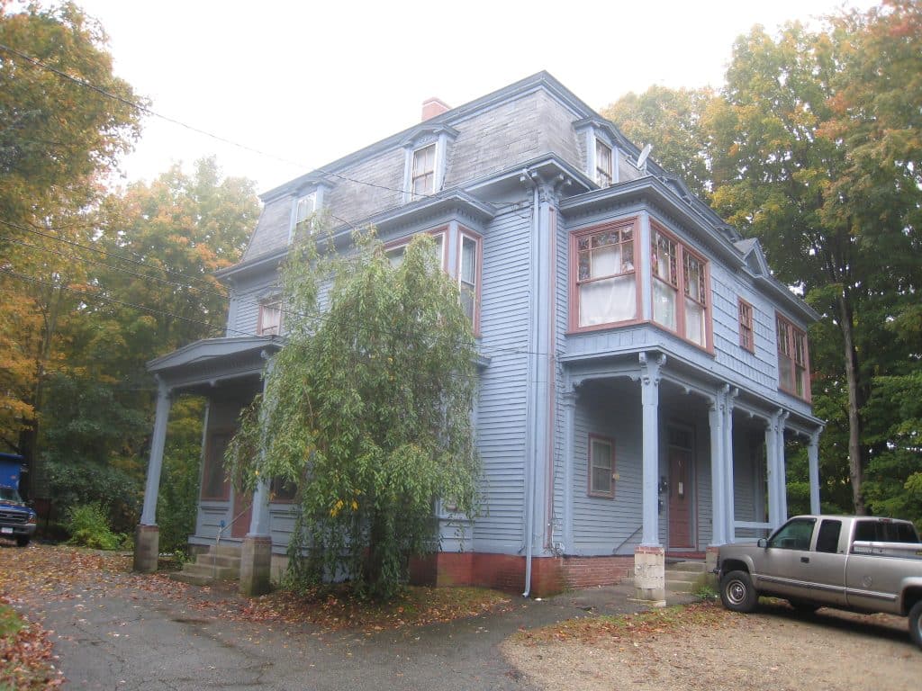 The blue and red Victorian exterior of the Lorenzo Maynard's mansion