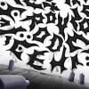Calligraffiti is seen on a wall. A few paint tubes are also present on the image.