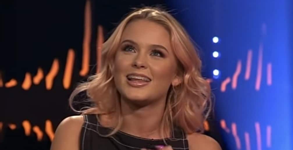 Zara Larsson appears during an interview with pastel pink hair and soft glam makeup.