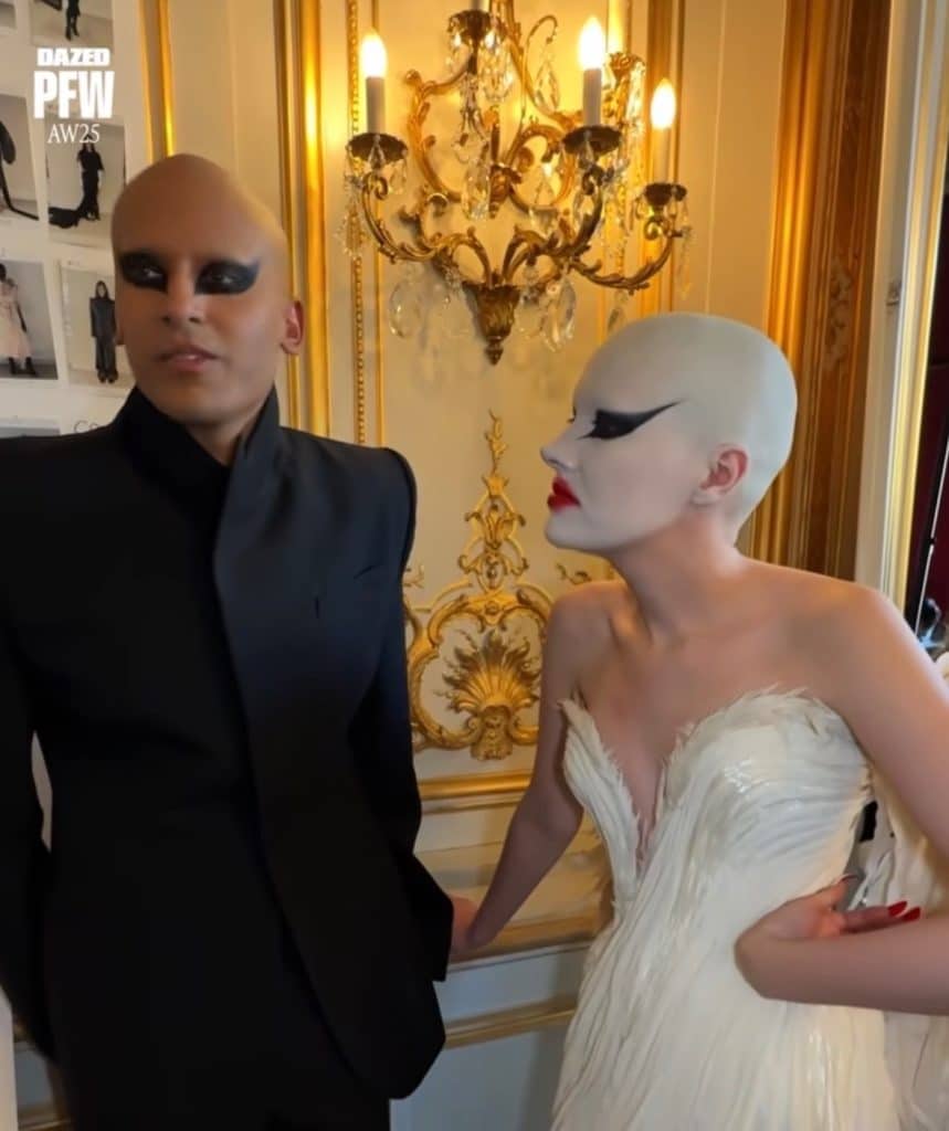 The creative directors of Materiales Fecales, Hannah Rose Dalton and Steven Raj Bhaskaran, answer questions in an interview while wearing dramatic black eye makeup.
