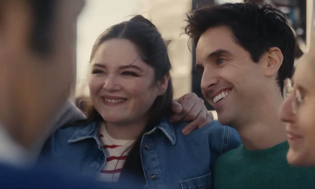 Characters Kayla and Jimmy from Hacks smiling next to each other.