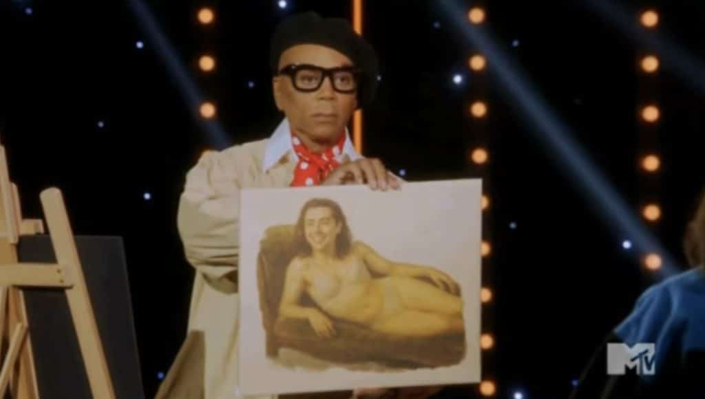 RuPaul holding a painting of Myki Meeks laying on a couch.