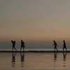 Silhouettes walking on the beach from "An Autumn Summer."